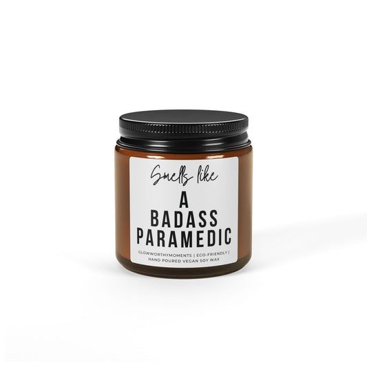 Candle jar with a label saying 'Smells like a badass paramedic' on a white background