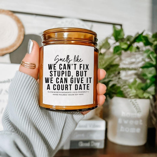 New attorney laughing with snarky candle after passing the bar exam