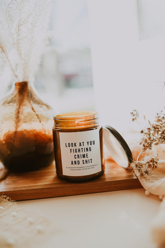 Funny cop candle on detective's desk next to case files