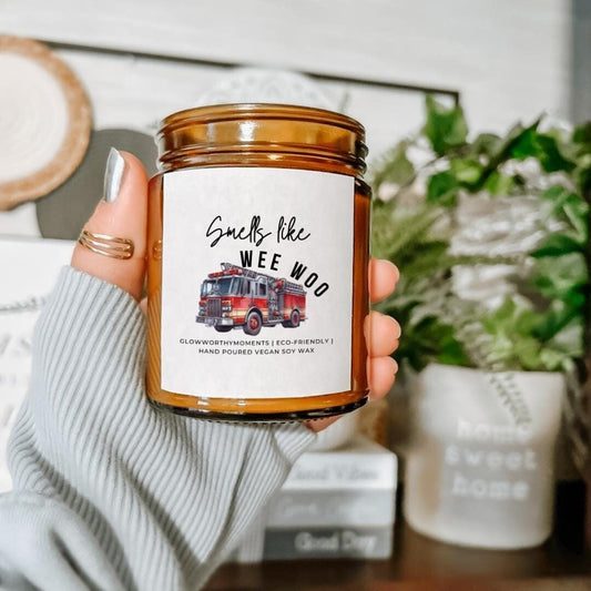New firefighter laughing with truck candle at graduation
