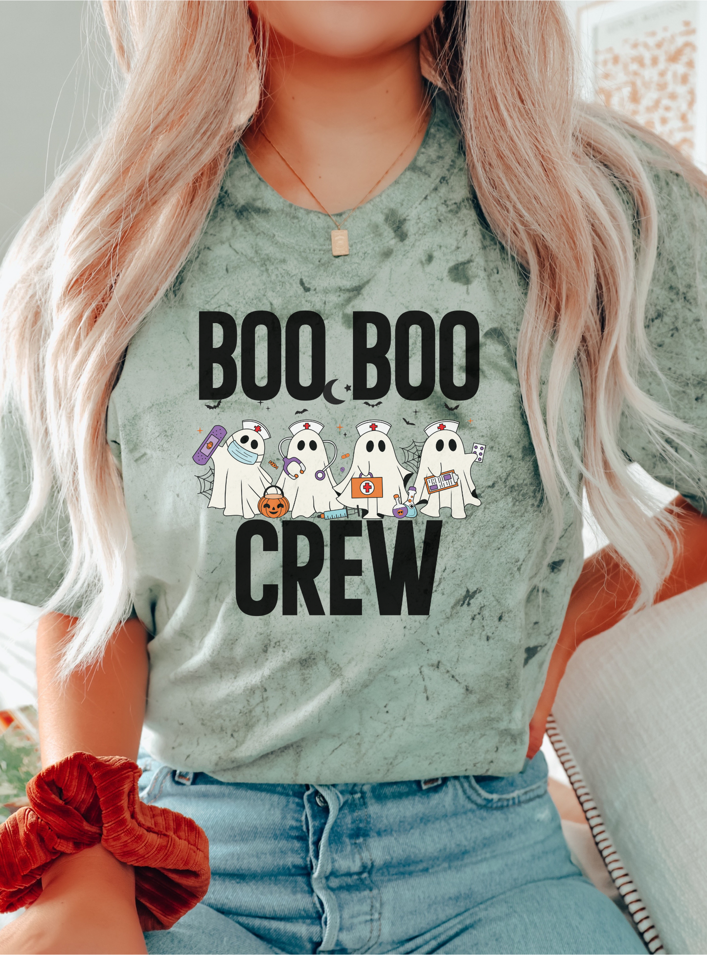 Person wearing a shirt with 'BOO BOO CREW' and ghost graphics.