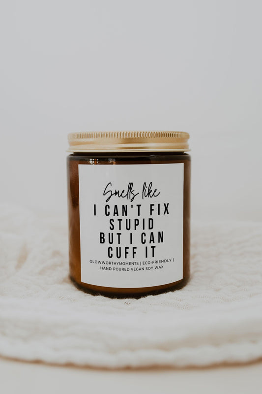 Police graduate laughing with sarcastic candle at ceremony