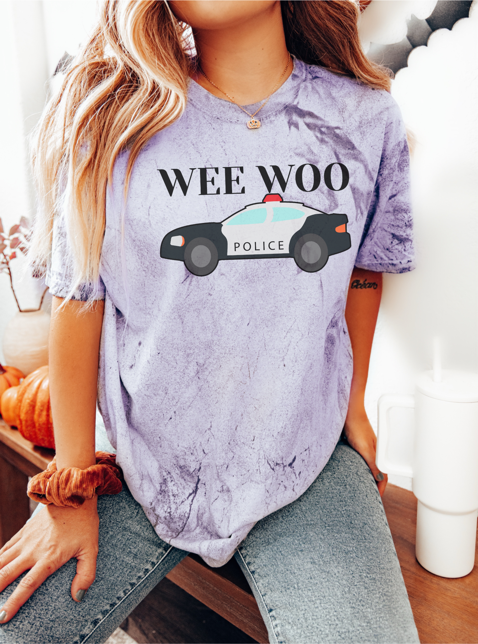 Close-up of screen-printed cop car design on tee