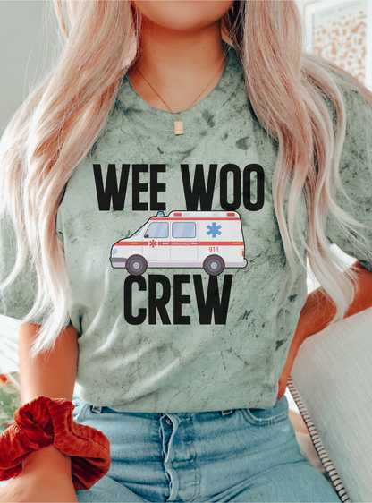 Person wearing a shirt with 'WEE WOO CREW' and an ambulance graphic.