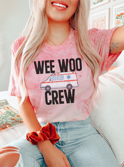Person wearing a pink t-shirt with 'WEE WOO CREW' text and ambulance graphic.