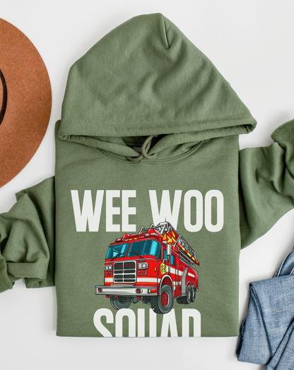 Green hoodie with a red fire truck graphic and 'WEE WOO SQUAD' text on a white background.